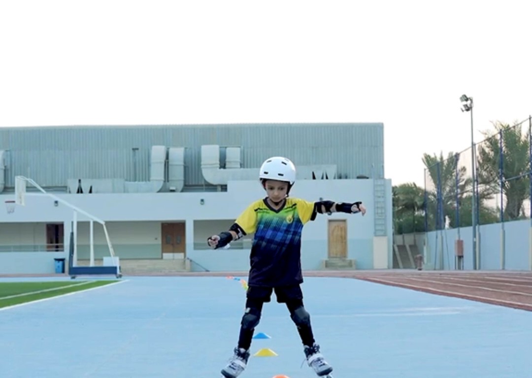 Child roller skating with full protective gear