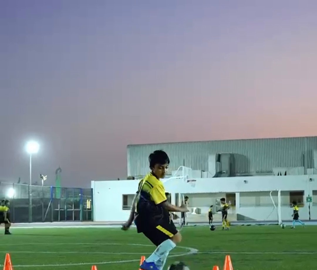 Child training with a football at FS Sports Academy